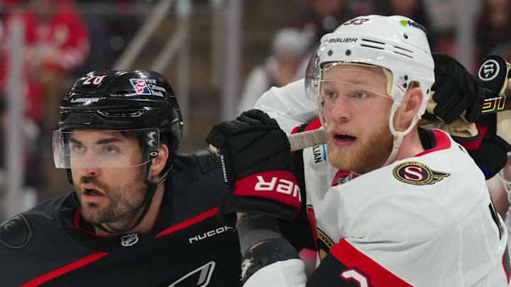 Apr 20, 2026; Raleigh, North Carolina, USA; Carolina Hurricanes left wing William Carrier (28) and Ottawa Senators defenseman Nikolas Matinpalo (33) battle during the third period in game two of the first round of the 2026 Stanley Cup Playoffs at Lenovo Center. Mandatory Credit: James Guillory-Imagn Images