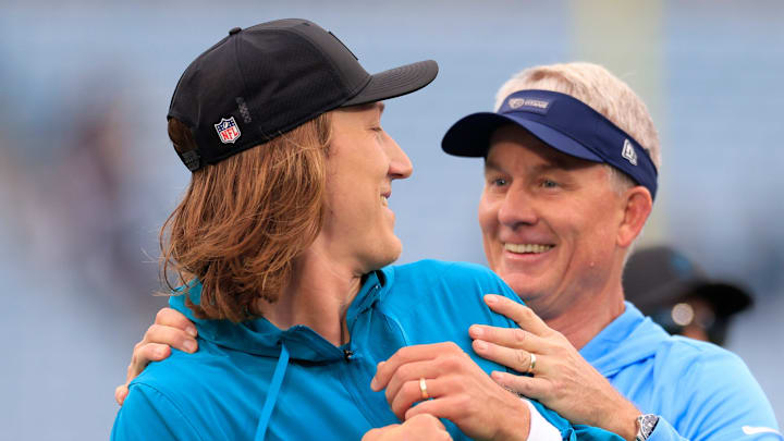 Jacksonville Jaguars quarterback Trevor Lawrence (16), left, is surprised by Tennessee Titans head coach Mike McCoy before an NFL football matchup at EverBank Stadium, Sunday, Jan. 4, 2026, in Jacksonville, Fla. [Corey Perrine/Florida Times-Union]