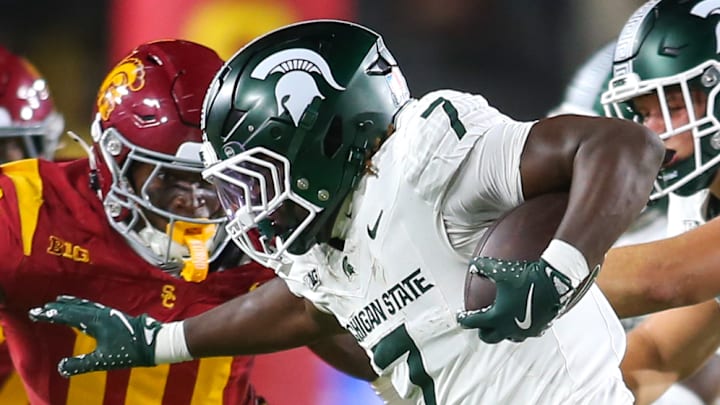 Michigan State RB Brandon Tullis carries the ball as USC DE Braylan Shelby closes in during the Spartans' and Trojans' matchup on Sept. 20, 2025. USC won 45-31.