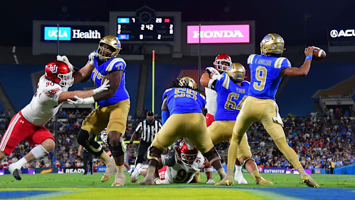 Aug 30, 2025; Pasadena, California, USA; UCLA Bruins quarterback Nico Iamaleava (9) throws as offensive lineman Courtland Ford (77) provides coverage against Utah Utes defensive end John Henry Daley (90) during the first half at Rose Bowl. Mandatory Credit: Gary A. Vasquez-Imagn Images Aug 30, 2025; Pasadena, California, USA; UCLA Bruins quarterback Nico Iamaleava (9) throws as offensive lineman Courtland Ford (77) provides coverage against Utah Utes defensive end John Henry Daley (90) during the first half at Rose Bowl. Mandatory Credit: Gary A. Vasquez-Imagn Images