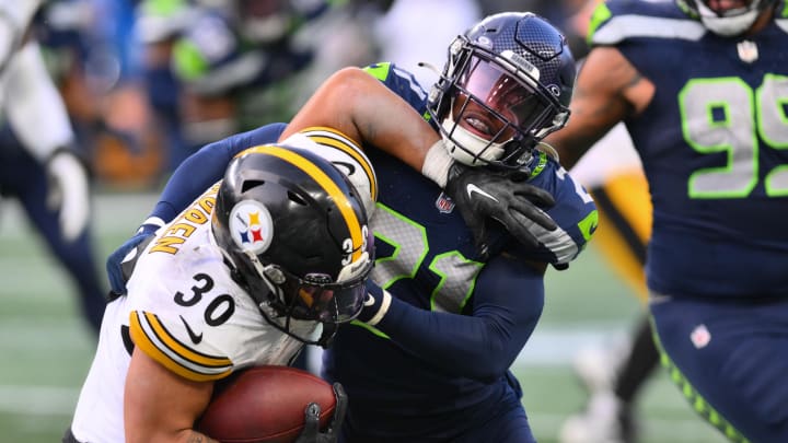 Dec 31, 2023; Seattle, Washington, USA; Seattle Seahawks cornerback Devon Witherspoon (21) tackles Pittsburgh Steelers running back Jaylen Warren (30) during the second half at Lumen Field. Mandatory Credit: Steven Bisig-USA TODAY Sports Dec 31, 2023; Seattle, Washington, USA; Seattle Seahawks cornerback Devon Witherspoon (21) tackles Pittsburgh Steelers running back Jaylen Warren (30) during the second half at Lumen Field. Mandatory Credit: Steven Bisig-USA TODAY Sports