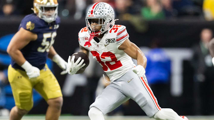 Jan 20, 2025; Atlanta, GA, USA; Ohio State Buckeyes running back TreVeyon Henderson (32) against the Notre Dame Fighting Irish during the CFP National Championship college football game at Mercedes-Benz Stadium. Mandatory Credit: Mark J. Rebilas-Imagn Images