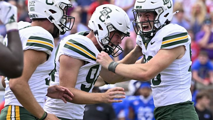Sep 6, 2025; Dallas, Texas, USA; Baylor Bears punter Palmer Williams (94) celebrates after place kicker Connor Hawkins (96) makes a game winning field goal to defeat the SMU Mustangs during the second overtime at Gerald J. Ford Stadium. Mandatory Credit: Jerome Miron-Imagn Images Sep 6, 2025; Dallas, Texas, USA; Baylor Bears punter Palmer Williams (94) celebrates after place kicker Connor Hawkins (96) makes a game winning field goal to defeat the SMU Mustangs during the second overtime at Gerald J. Ford Stadium. Mandatory Credit: Jerome Miron-Imagn Images