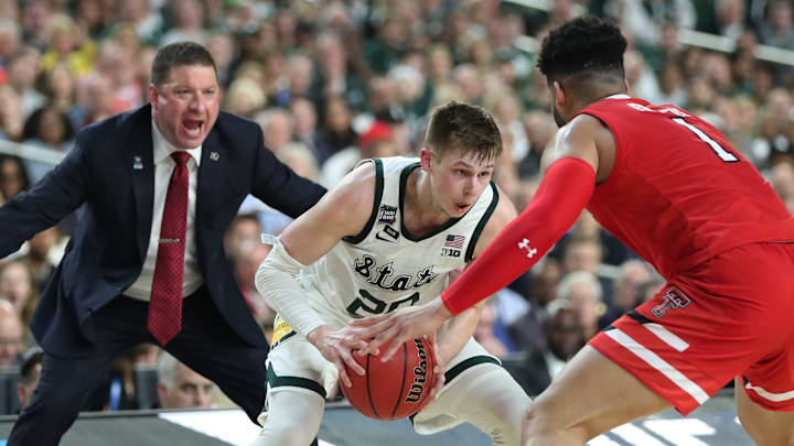 Texas Tech head coach Chris Beard is seen as Michigan State guard Matt McQuaid (20) looks to move the ball around Texas Tech guard Brandone Francis (1) in the first half of the Spartan's Final Four game at U.S. Bank Stadium in Minneapolis, Minnesota on Saturday, April 06, 2019.

Ust Jh3 5987