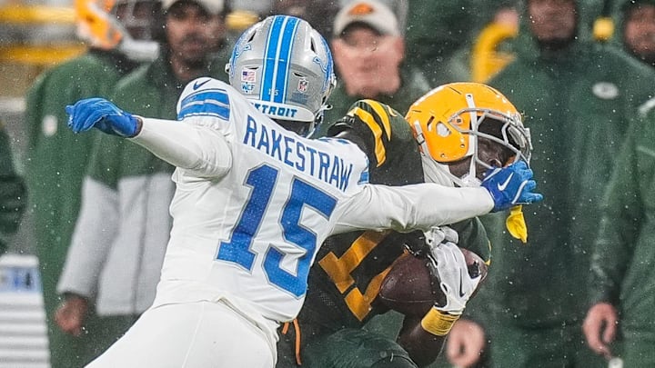 Detroit Lions cornerback Ennis Rakestraw Jr. (15) tackles Green Bay Packers wide receiver Jayden Reed (11) Detroit Lions cornerback Ennis Rakestraw Jr. (15) tackles Green Bay Packers wide receiver Jayden Reed (11)