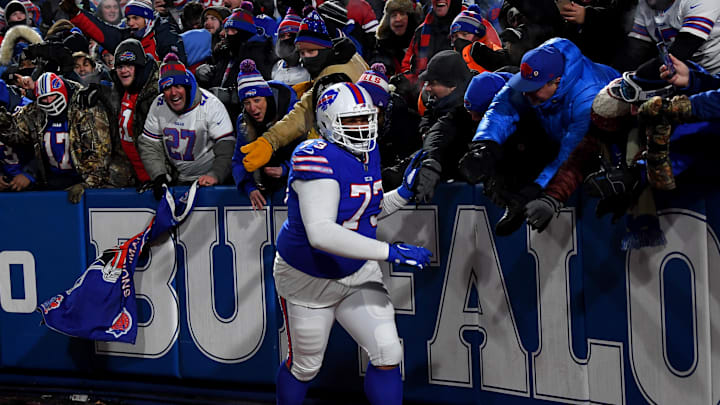Jan 15, 2022; Orchard Park, New York, USA; Buffalo Bills offensive tackle Dion Dawkins (73) celebrates with fans after the Bills defeated the New England Patriots 47-17 in the AFC Wild Card playoff game at Highmark Stadium. Jan 15, 2022; Orchard Park, New York, USA; Buffalo Bills offensive tackle Dion Dawkins (73) celebrates with fans after the Bills defeated the New England Patriots 47-17 in the AFC Wild Card playoff game at Highmark Stadium.