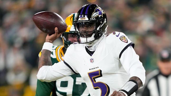 Dec 27, 2025; Green Bay, Wisconsin, USA; Baltimore Ravens quarterback Tyler Huntley (5) looks to throw a pass as Green Bay Packers defensive tackle Jordon Riley (97) defends during the first quarter at Lambeau Field. Mandatory Credit: Kayla Wolf-Imagn Images