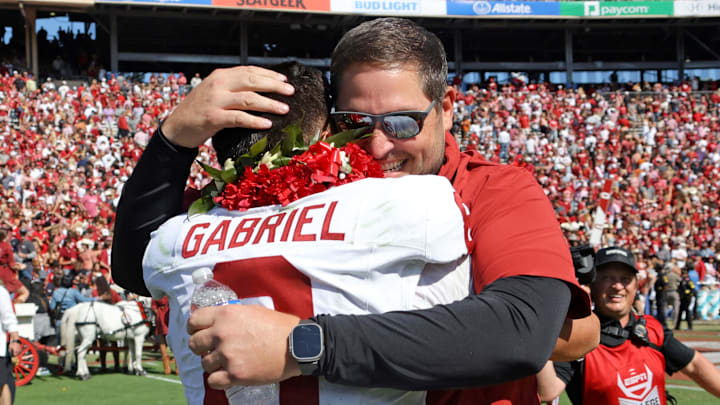 Oklahoma offensive coordinator Jeff Lebby hugs quarterback Dillon Gabriel (8) after the Red River Rivalry college football game between the University of Oklahoma Sooners and the University of Texas Longhorns at the Cotton Bowl in Dallas. Oklahoma won 34-30. Oklahoma offensive coordinator Jeff Lebby hugs quarterback Dillon Gabriel (8) after the Red River Rivalry college football game between the University of Oklahoma Sooners and the University of Texas Longhorns at the Cotton Bowl in Dallas. Oklahoma won 34-30.