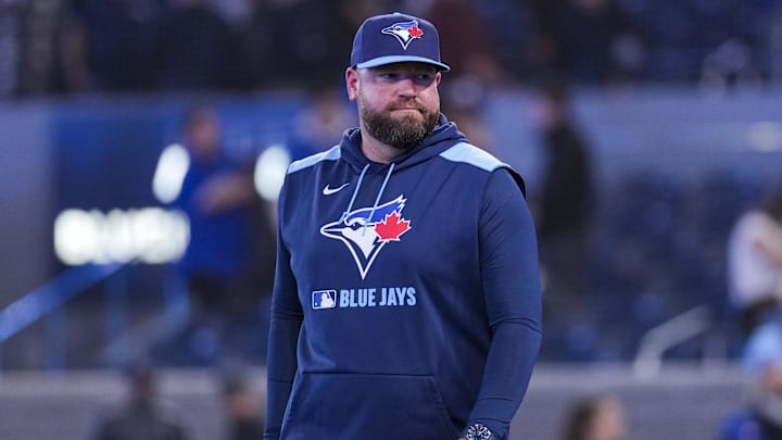 Mar 31, 2025; Toronto, Ontario, CAN; Toronto Blue Jays manager John Schneider (14) celebrates defeating the Washington Nationals  at Rogers Centre.