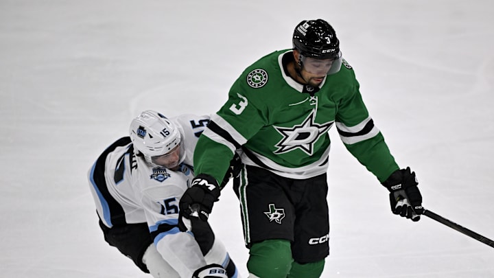 Apr 12, 2025; Dallas, Texas, USA; Dallas Stars defenseman Matt Dumba (3) keeps the puck away from Utah Hockey Club center Alexander Kerfoot (15) during the first period at the American Airlines Center. Mandatory Credit: Jerome Miron-Imagn Images