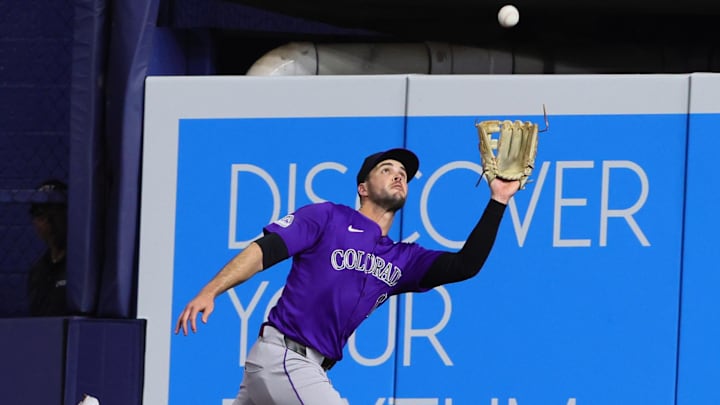 May 1, 2024; Miami, Florida, USA; Colorado Rockies right fielder Sean Bouchard (12) catches a fly ball to retire Miami Marlins catcher Christian Bethancourt (not pictured) during the third inning at loanDepot Park. Mandatory Credit: Sam Navarro-Imagn Images
