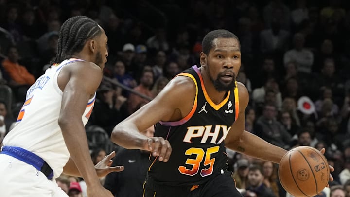 Dec 15, 2023; Phoenix, Arizona, USA; Phoenix Suns forward Kevin Durant (35) drives on New York Knicks guard Immanuel Quickley (5) in the first half at Footprint Center. Mandatory Credit: Rick Scuteri-Imagn Images