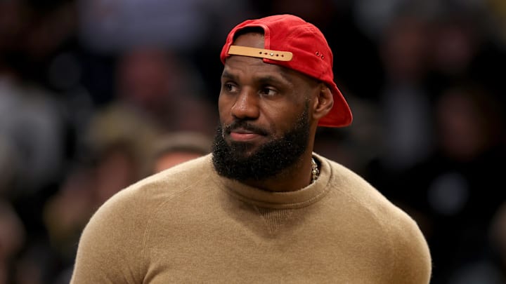 Los Angeles Lakers forward LeBron James sits on the sidelines as he nurses an injury.