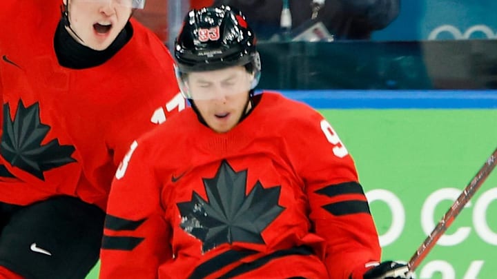 Feb 18, 2026; Milan, Italy; Mitch Marner of Canada celebrates with Thomas Harley after scoring their fourth and game-winning goal against Czechia in a men's ice hockey quarterfinal during the Milano Cortina 2026 Olympic Winter Games at Milano Santagiulia Ice Hockey Arena. Mandatory Credit: Geoff Burke-Imagn Images
