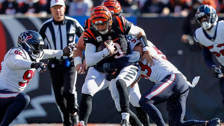 Nov 12, 2023; Cincinnati, Ohio, USA; Cincinnati Bengals quarterback Joe Burrow (9) runs with the ball against Houston Texans linebacker Blake Cashman (53) in the first half at Paycor Stadium. Mandatory Credit: Katie Stratman-USA TODAY Sports