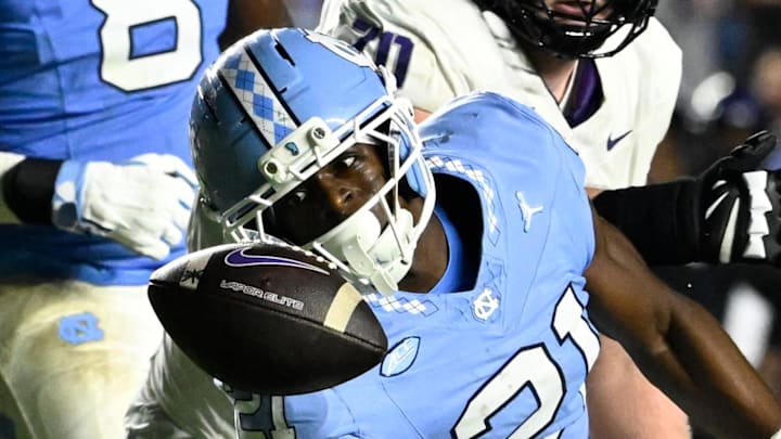 Sep 1, 2025; Chapel Hill, North Carolina, USA; North Carolina Tar Heels defensive back Kaleb Cost (21) intercepts a pass in the second quarter at Kenan Stadium. Mandatory Credit: Bob Donnan-Imagn Images