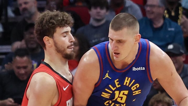 Nov 12, 2023; Houston, Texas, USA; Denver Nuggets center Nikola Jokic (15) dribbles against Houston Rockets center Alperen Sengun (28) in the first quarter  at Toyota Center. Mandatory Credit: Thomas Shea-Imagn Images