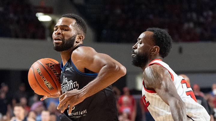 La Familia's Andrew Harrison (5) makes his way around The Ville's Russ Smith (6) during their game on Monday, July 29, 2024 at Freedom Hall in Louisville, Ky. during the quarter finals of The Basketball Tournament.