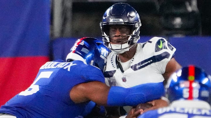 Oct 2, 2023; East Rutherford, New Jersey, USA; Seattle Seahawks quarterback Geno Smith (7) gets sacked by New York Giants linebacker Kayvon Thibodeaux (5) in the 1st quarter at MetLife Stadium. Mandatory Credit: Robert Deutsch-Imagn Images