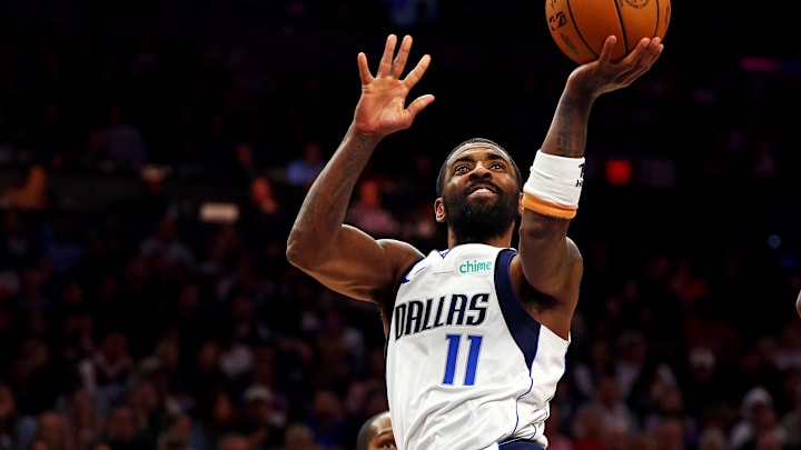 Dec 27, 2024; Phoenix, Arizona, USA; Dallas Mavericks guard Kyrie Irving (11) shoots the ball against Phoenix Suns forward Josh Okogie (2) during the third quarter at Footprint Center. Mandatory Credit: Mark J. Rebilas-Imagn Images
