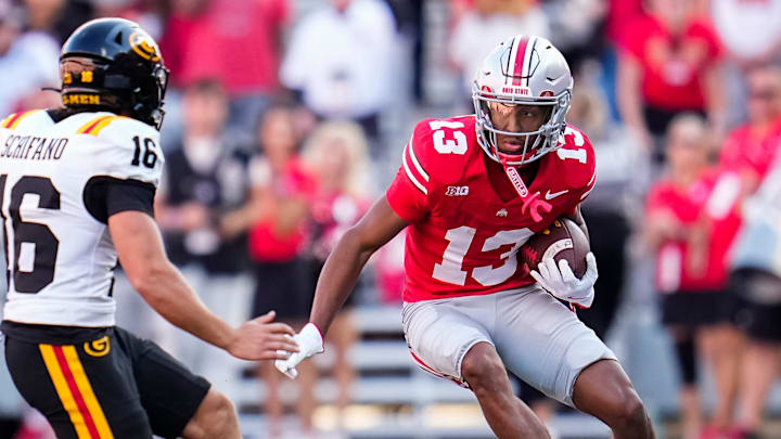 Ohio State Buckeyes wide receiver Bryson Rodgers (13) runs around Grambling State Tigers punter Johnny Schifano (16) during the NCAA football game at Ohio Stadium on Sept. 6, 2025.