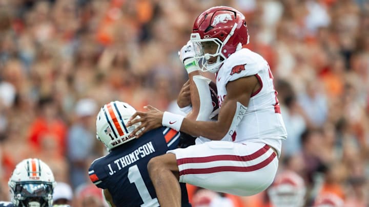Arkansas Razorbacks quarterback Taylen Green (10) fails to hurdle over Auburn Tigers defensive back Jerrin Thompson (1) at Jordan-Hare Stadium in Auburn, Ala.