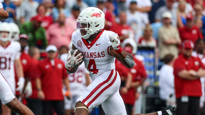 Sep 20, 2025; Memphis, Tennessee, USA; Arkansas Razorbacks running back Mike Washington Jr. (4) runs with the ball against the Memphis Tigers during the second half at Simmons Bank Liberty Stadium. Mandatory Credit: Wesley Hale-Imagn Images