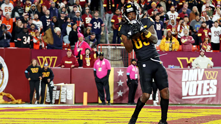 Oct 27, 2024; Landover, Maryland, USA; Washington Commanders wide receiver Noah Brown (85) catches a Hail Mary pass with no time left to beat the Chicago Bears at Commanders Field. Mandatory Credit: Peter Casey-Imagn Images