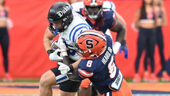 Duke Blue Devils tight end Jeremiah Hasley (85) is tackled by Syracuse Orange linebacker James Heard (6) in the second quarter at the JMA Wireless Dome.