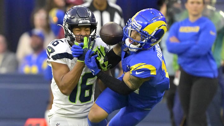Jan 5, 2025; Inglewood, California, USA; Los Angeles Rams cornerback Cobie Durant (14) breaks up a pass for Seattle Seahawks wide receiver Tyler Lockett (16) in the second half at SoFi Stadium. Mandatory Credit: Jayne Kamin-Oncea-Imagn Images