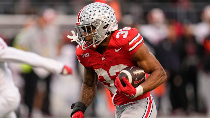 Ohio State Buckeyes running back TreVeyon Henderson (32) runs upfield during the NCAA football game against the Indiana Hoosiers at Ohio Stadium in Columbus on Monday, Nov. 25, 2024. Ohio State won 38-15.
