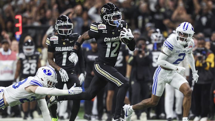 Dec 28, 2024; San Antonio, TX, USA; Colorado Buffaloes wide receiver Travis Hunter (12) runs with the ball during the second quarter against the Brigham Young Cougars at Alamodome. Mandatory Credit: Troy Taormina-Imagn Images