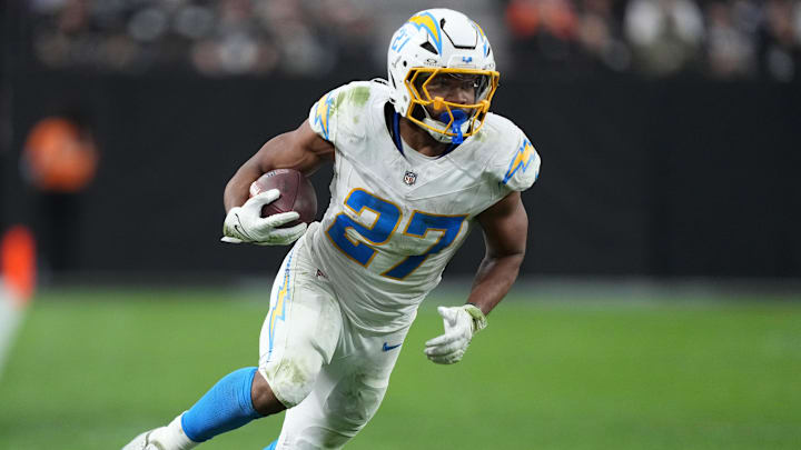 Jan 5, 2025; Paradise, Nevada, USA; Los Angeles Chargers running back J.K. Dobbins (27) carries the ball against the Las Vegas Raiders in the second half at Allegiant Stadium. 