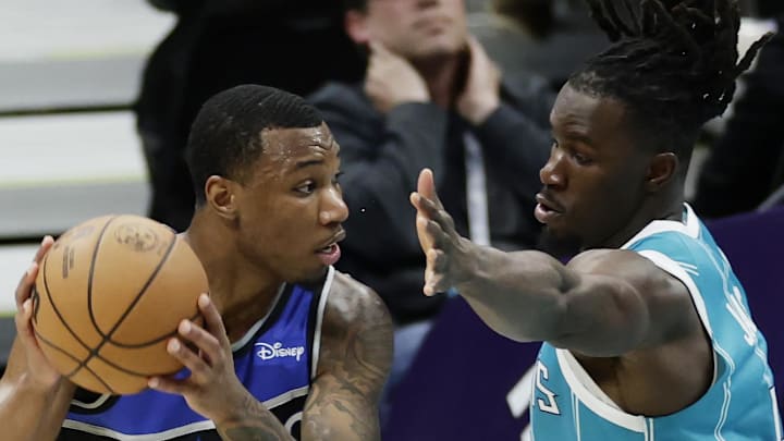 Orlando Magic forward Jamal Cain is guarded by Charlotte Hornets guard Sion James.