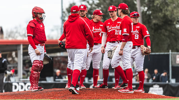 Nebraska baseball players meet on the mound during a game against Louisiana on Feb. 22, 2025.