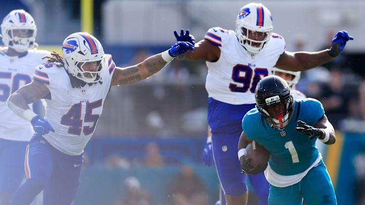 Jacksonville Jaguars running back Travis Etienne Jr. (1) rushes for yards during the third quarter of an NFL football AFC Wild Card playoff matchup, Sunday, Jan. 11, 2026, in Jacksonville, Fla. The Bills defeated the Jaguars 27-24. [Corey Perrine/Florida Times-Union]