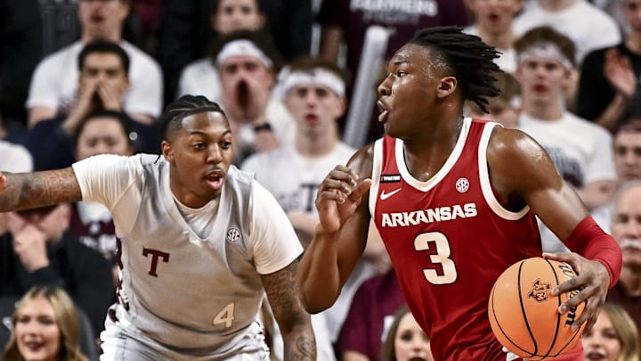Arkansas Razorbacks forward Adou Thiero (3) drives against Texas A&M Aggies guard Wade Taylor IV (4) during the first half at Reed Arena.