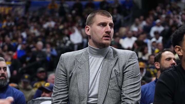 Jan 9, 2026; Denver, Colorado, USA; Denver Nuggets center Nikola Jokic (15) reacts from the bench in the first quarter against the Atlanta Hawks at Ball Arena.