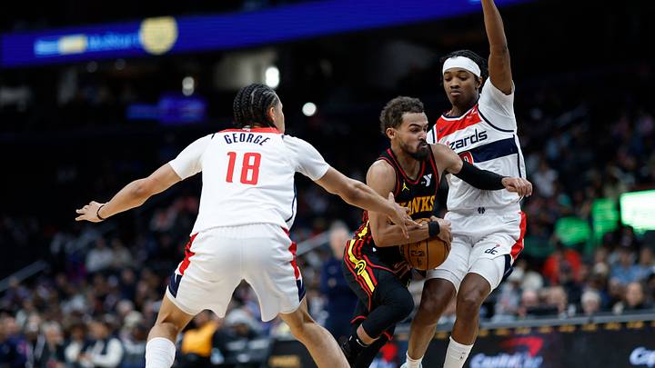 Oct 30, 2024; Washington, District of Columbia, USA; Atlanta Hawks guard Trae Young (11) drives to the basket as Washington Wizards forward Kyshawn George (18) and Wizards guard Bilal Coulibaly (0) defend in the first half at Capital One Arena. Mandatory Credit: Geoff Burke-Imagn Images Oct 30, 2024; Washington, District of Columbia, USA; Atlanta Hawks guard Trae Young (11) drives to the basket as Washington Wizards forward Kyshawn George (18) and Wizards guard Bilal Coulibaly (0) defend in the first half at Capital One Arena. Mandatory Credit: Geoff Burke-Imagn Images