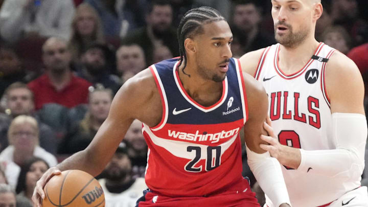 Apr 11, 2025; Chicago, Illinois, USA; Chicago Bulls center Nikola Vucevic (9) defends Washington Wizards forward Alex Sarr (20) during the first quarter at United Center. Mandatory Credit: David Banks-Imagn Images