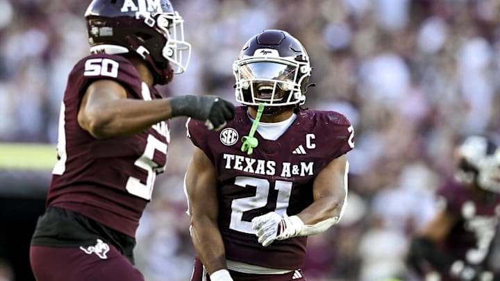Texas A&M Aggies linebacker Taurean York (21) celebrates with defensive end Dayon Hayes (50) against the Auburn Tigers during the fourth quarter at Kyle Field.