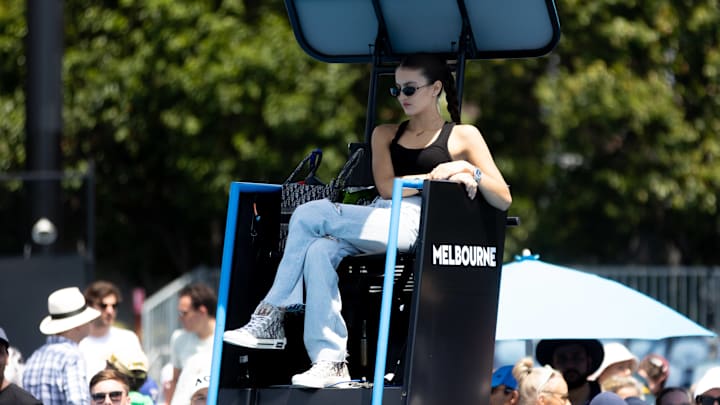 Nina Ghaibi, girlfriend of Felix Auger-Aliassime of Canada, watches him practice during the Australian Open.