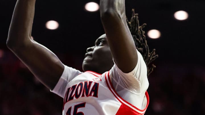 Feb 14, 2026; Tucson, Arizona, USA; Arizona Wildcats forward Sidi Gueye (15) makes a basket over Texas Tech Red Raiders forward JT Toppin (15) during the second half of the game at McKale Memorial Center. Mandatory Credit: Aryanna Frank-Imagn Images