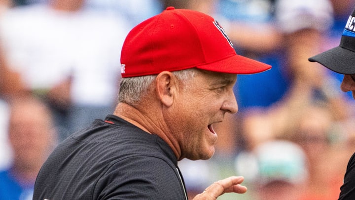 Jun 15, 2024; Omaha, NE, USA; NC State Wolfpack head coach Elliott Avent talks with an official during the seventh inning against the Kentucky Wildcats at Charles Schwab Field Omaha. Mandatory Credit: Dylan Widger-Imagn Images