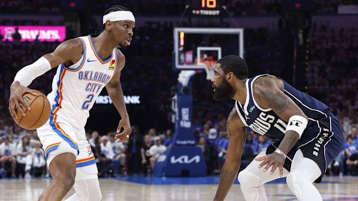 May 7, 2024; Oklahoma City, Oklahoma, USA; Oklahoma City Thunder guard Shai Gilgeous-Alexander (2) works his way to the basket against Dallas Mavericks guard Kyrie Irving (11) during the second quarter of game one of the second round for the 2024 NBA playoffs at Paycom Center. Mandatory Credit: Alonzo Adams-Imagn Images