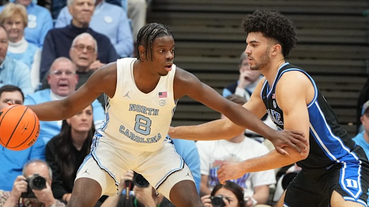 Feb 7, 2026; Chapel Hill, North Carolina, USA; North Carolina Tar Heels forward Caleb Wilson (8) with the ball as Duke Blue Devils forward Cameron Boozer (12) defends in the first half at Dean E. Smith Center.