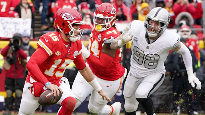 Dec 25, 2023; Kansas City, Missouri, USA; Kansas City Chiefs quarterback Patrick Mahomes (15) and Las Vegas Raiders defensive end Maxx Crosby (98) during the game at GEHA Field at Arrowhead Stadium. Mandatory Credit: Denny Medley-Imagn Images