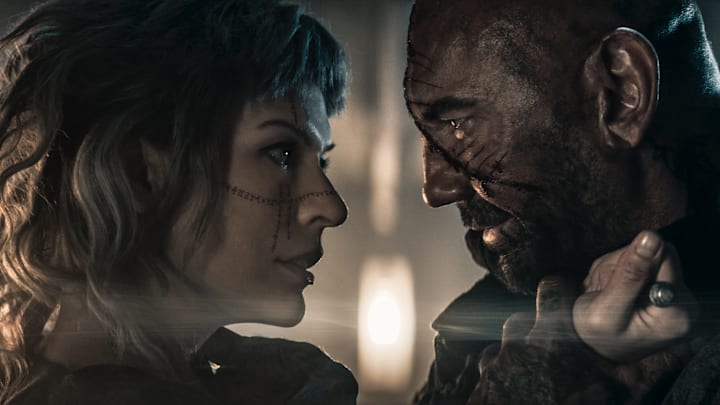 Gray Alys (Milla Jovovich) and Boyce (Dave Bautista) in In the Lost Lands.