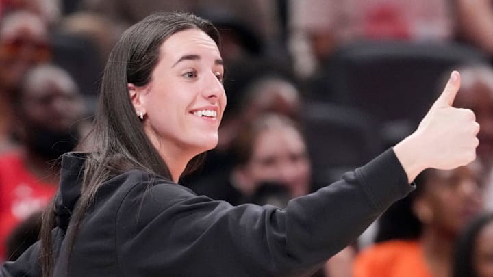 Indiana Fever's Caitlin Clark (22) gives a thumbs up to Los Angeles Sparks's Kelsey Plum (10) after she travels with the ball Saturday, July 19, 2025, during the WNBA All-Star Game at Gainbridge Fieldhouse in Indianapolis.