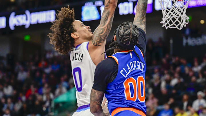 Mar 11, 2026; Salt Lake City, Utah, USA; New York Knicks guard Jordan Clarkson (00) jumps to block a shot from Utah Jazz forward Andersson Garcia (0) during the second half at Delta Center. Mandatory Credit: Peter Creveling-Imagn Images